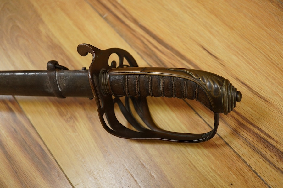 An 1845 pattern infantry officer’s sword by Henry Wilkinson, number 19387, regulation hilt, (fish skin covering missing), in its iron scabbard. Condition - fair to good.